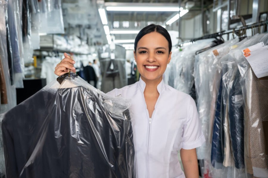Teen Women Holding Suit After Dry Cleaning